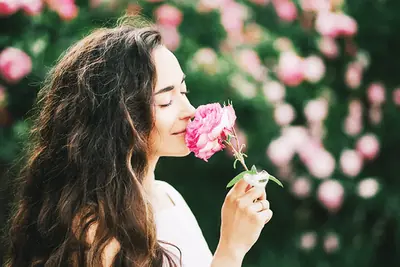 Woman smelling a rose
